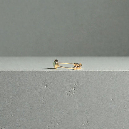 African Turquoise Gemstone Fidget Ring on a gray surface with a gray background