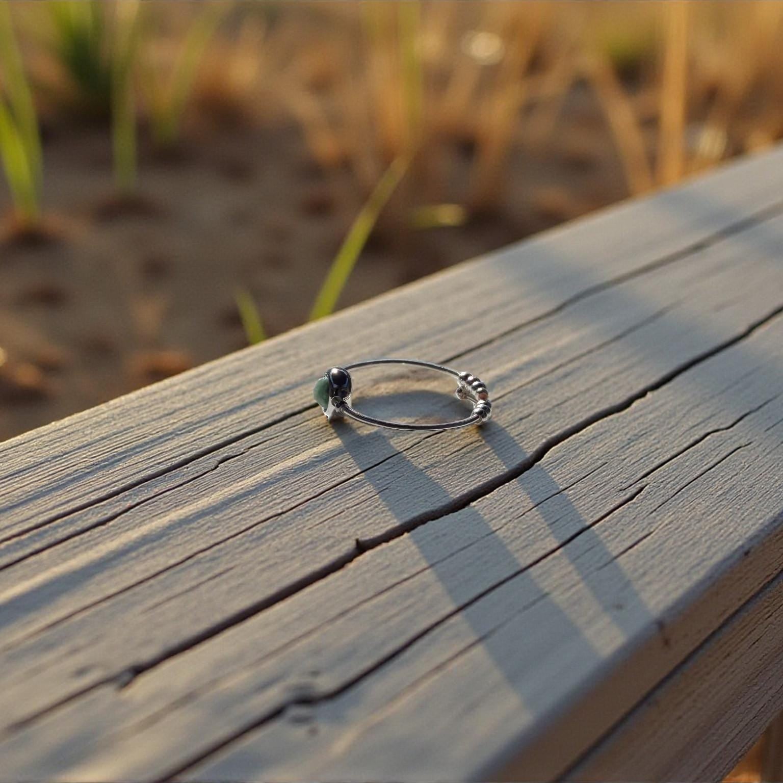 Emerald Ring on a wooden surface with a natural background