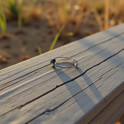 Emerald Ring on a wooden surface with a natural background